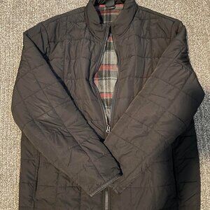 Black quilted puffer jacket with zipper closure, pockets, and fleece lining